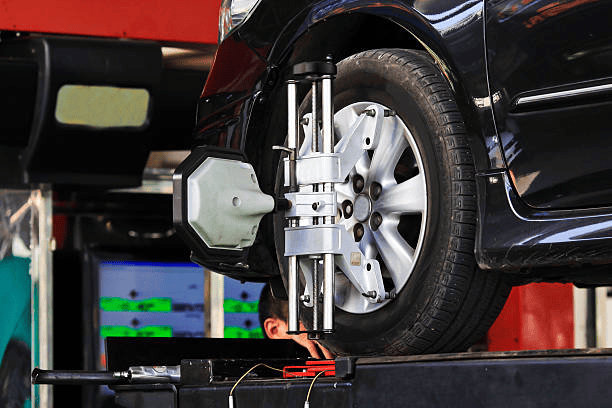 Technician performing wheel alignment